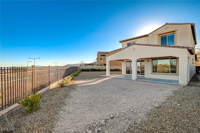 rear view of property featuring a patio