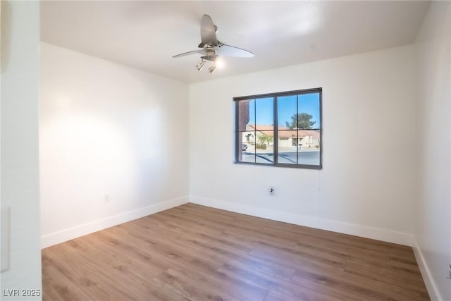 spare room featuring hardwood / wood-style flooring and ceiling fan