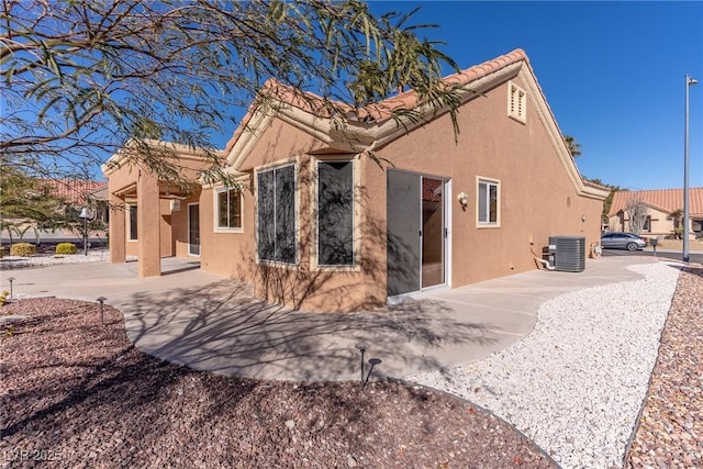 rear view of house with cooling unit and a patio area