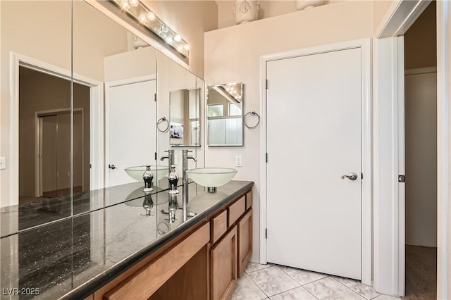 bathroom with tile patterned floors and vanity