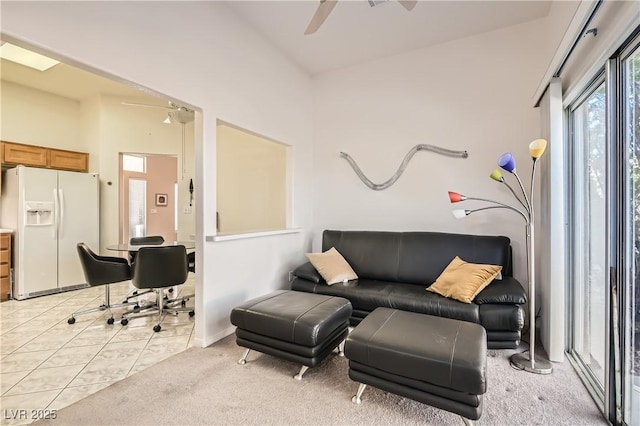 living room with ceiling fan and light colored carpet