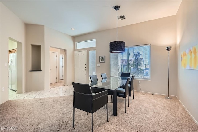 dining room with light colored carpet