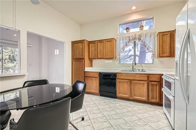 kitchen featuring sink, white appliances, and light tile patterned floors