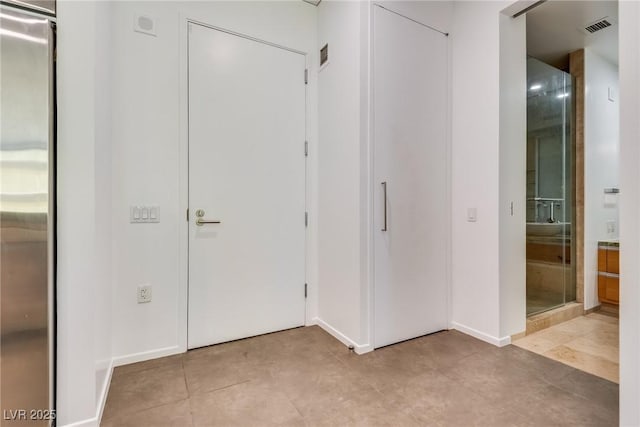 hall with light tile patterned flooring