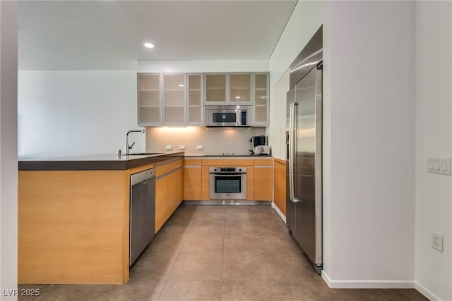 kitchen with sink, light tile patterned floors, and appliances with stainless steel finishes