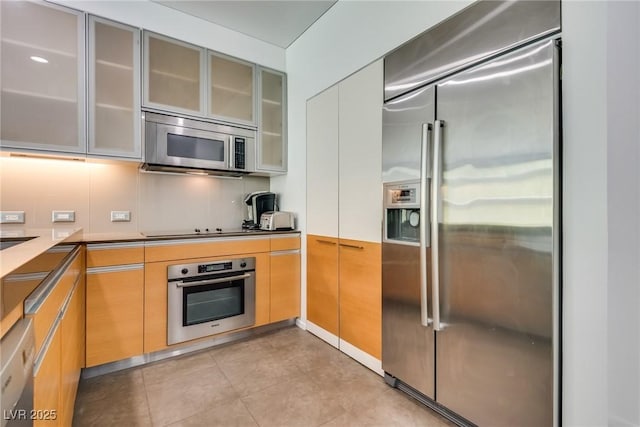 kitchen with light tile patterned floors and appliances with stainless steel finishes