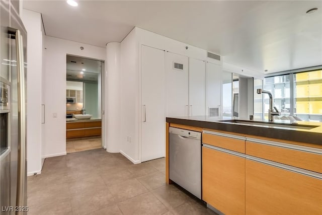 kitchen with sink and stainless steel dishwasher