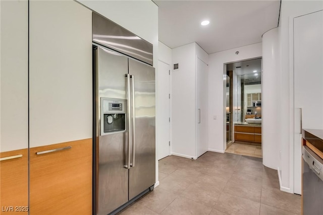 kitchen with white dishwasher and stainless steel built in refrigerator