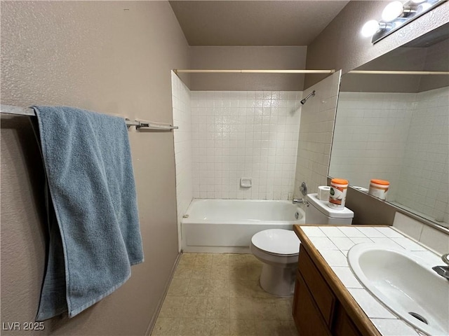 full bathroom featuring vanity, toilet, and tiled shower / bath