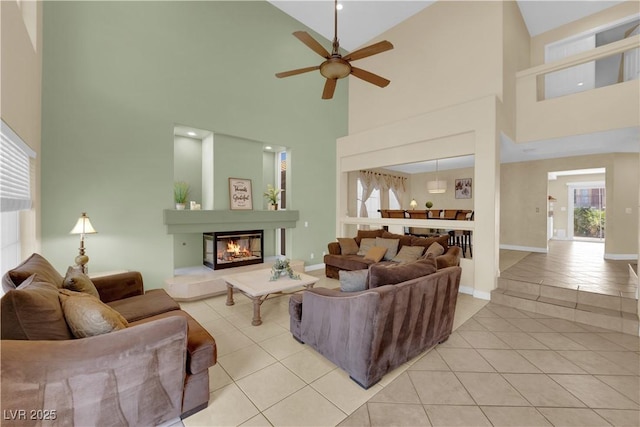 living room with ceiling fan and light tile patterned floors