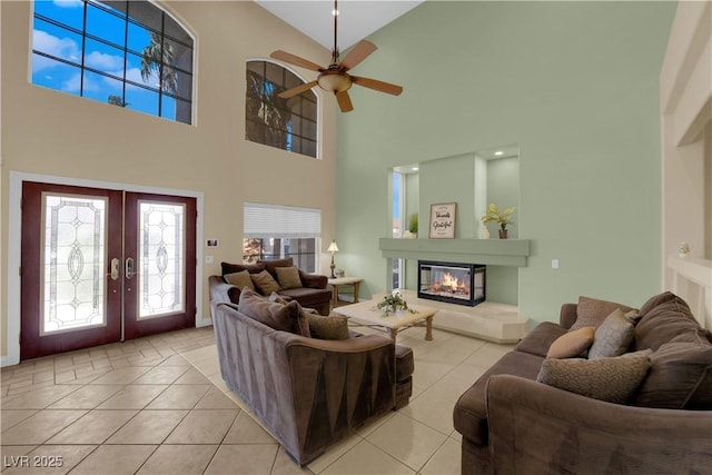 living room featuring light tile patterned flooring, ceiling fan, and french doors