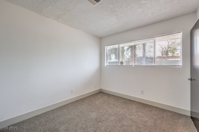 unfurnished room with plenty of natural light, a textured ceiling, and carpet