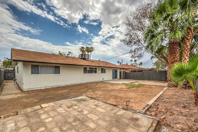 rear view of property featuring central AC unit and a patio area