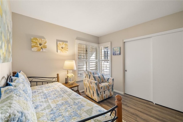 bedroom with dark hardwood / wood-style floors and a closet