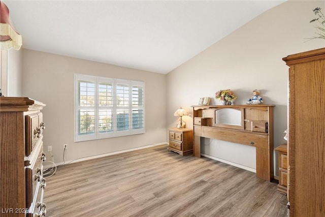 miscellaneous room with light wood-type flooring and lofted ceiling