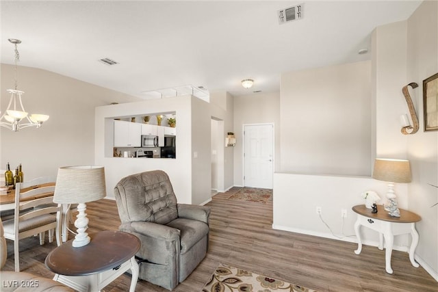 living area featuring wood-type flooring and a chandelier