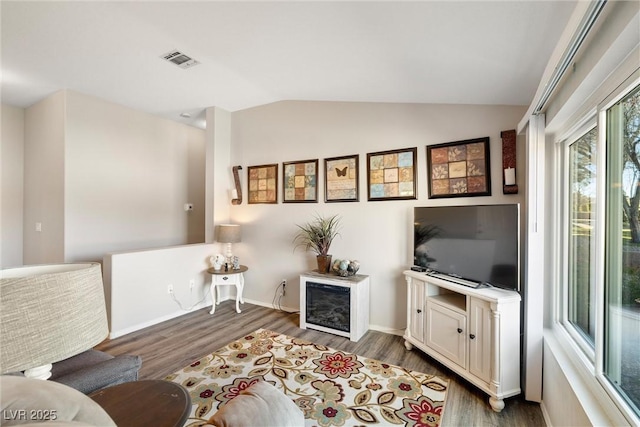 living room featuring dark hardwood / wood-style floors and lofted ceiling