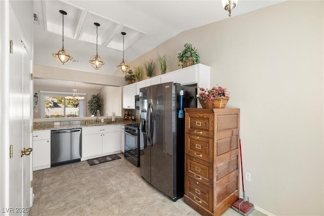 kitchen with vaulted ceiling, white cabinetry, sink, pendant lighting, and stainless steel appliances