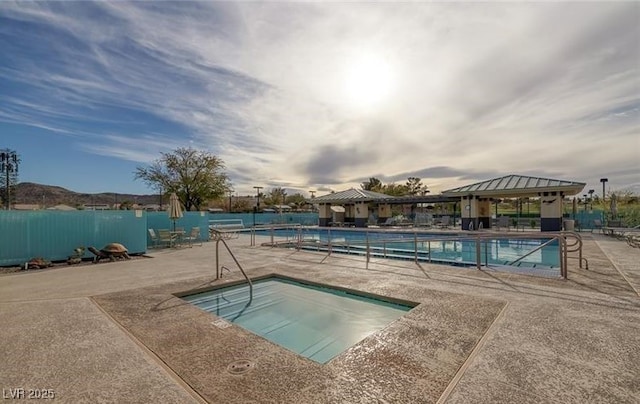 view of pool with a community hot tub, a patio area, and a gazebo