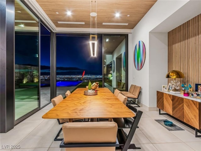 dining area featuring light tile patterned flooring, wood ceiling, and a wall of windows