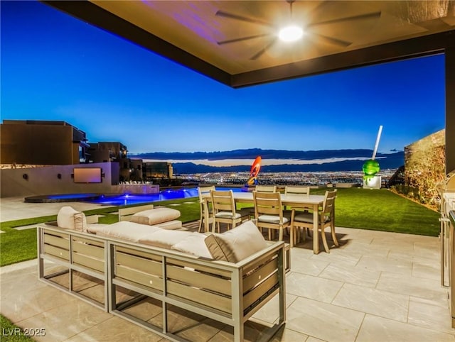 view of patio featuring a mountain view, an outdoor hangout area, and ceiling fan