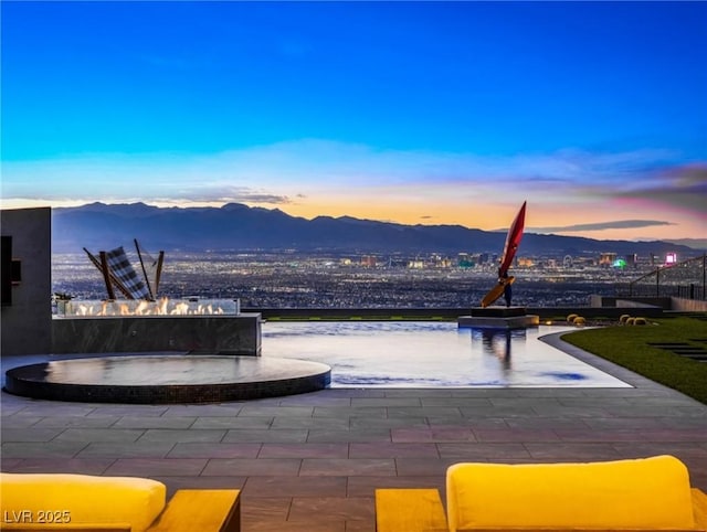 patio terrace at dusk with a mountain view