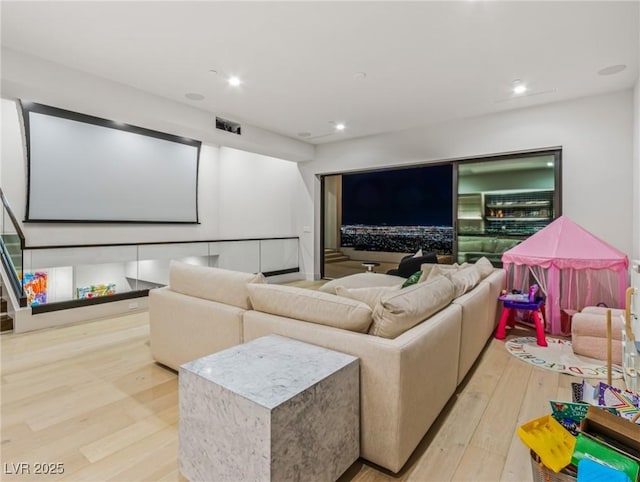 home theater room featuring light hardwood / wood-style floors