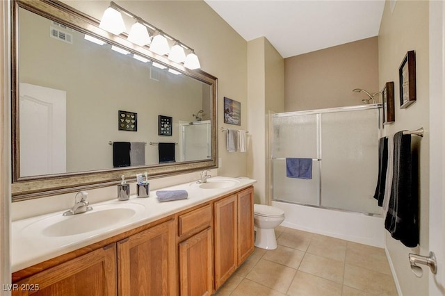 full bathroom featuring vanity, toilet, enclosed tub / shower combo, and tile patterned flooring