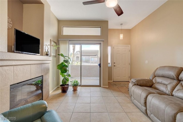 living room with ceiling fan, light tile patterned floors, and a fireplace