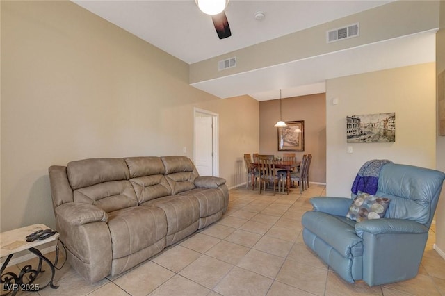 living room featuring light tile patterned flooring and ceiling fan