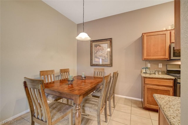 tiled dining area featuring lofted ceiling