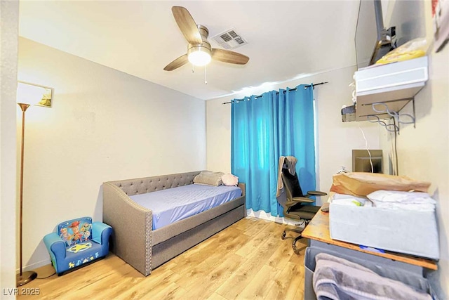 bedroom with ceiling fan and hardwood / wood-style flooring