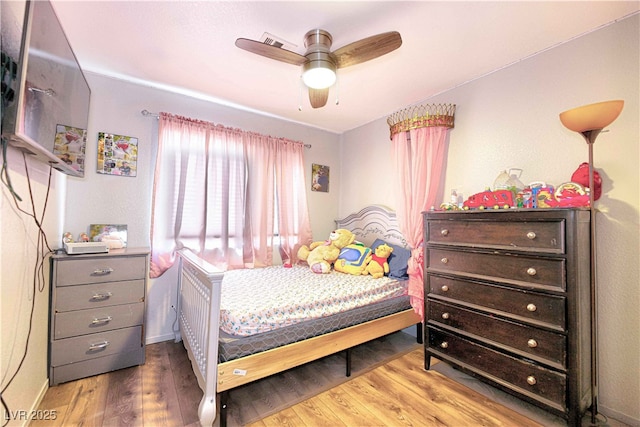 bedroom with ceiling fan and hardwood / wood-style floors