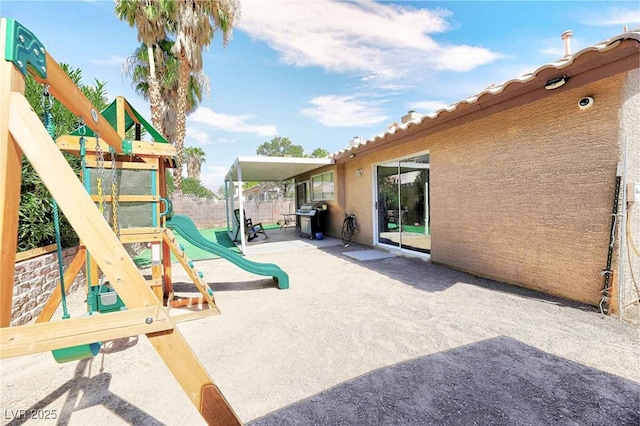 view of jungle gym with a patio area