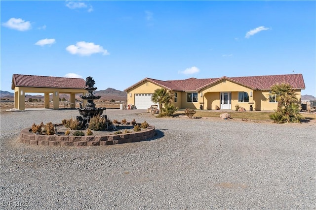 view of front facade featuring a garage and a mountain view