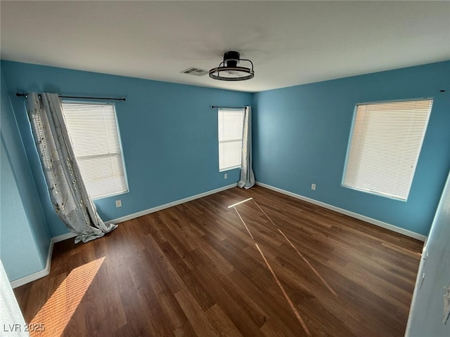 unfurnished room with ceiling fan and dark hardwood / wood-style floors