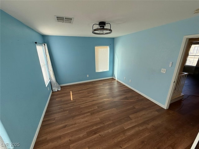 empty room featuring dark hardwood / wood-style flooring