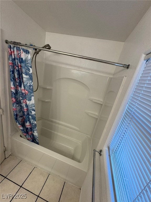 bathroom with shower / bath combination with curtain and tile patterned floors