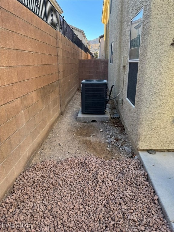 view of side of home with central air condition unit