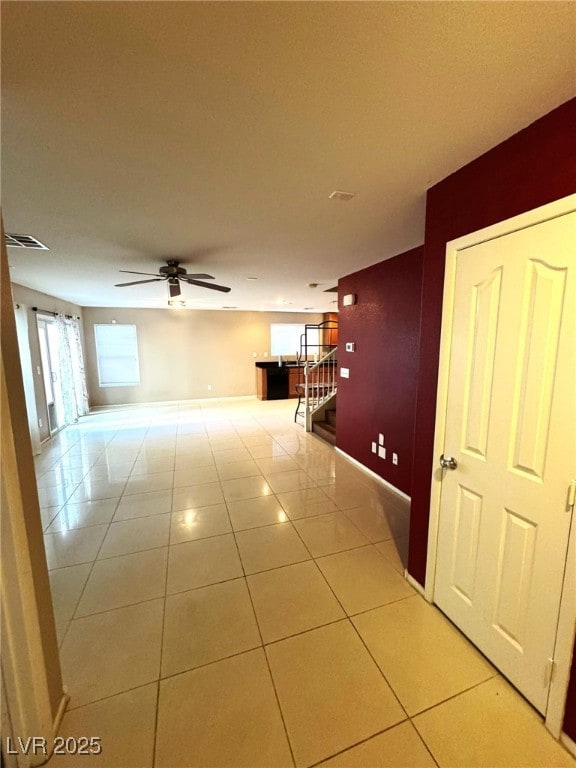 corridor featuring light tile patterned flooring