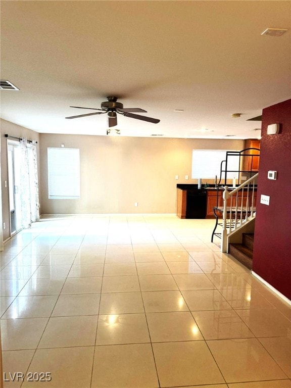 tiled spare room with ceiling fan