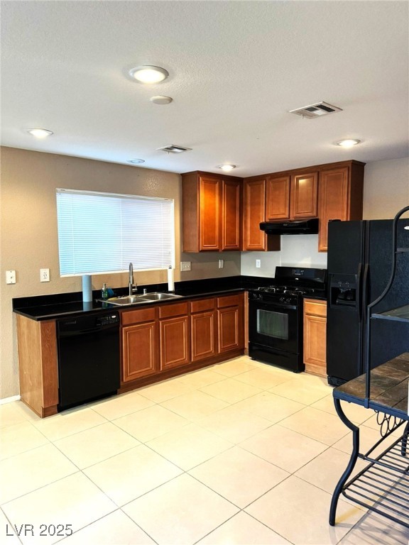 kitchen with sink, light tile patterned flooring, and black appliances