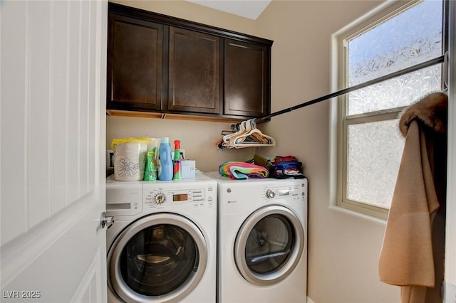 washroom with cabinets and washing machine and dryer