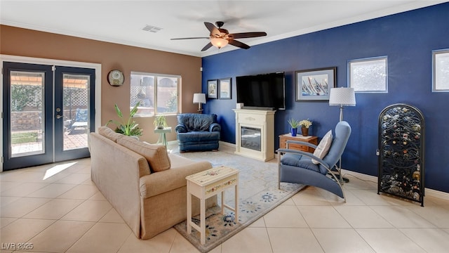 tiled living room with ceiling fan, ornamental molding, and french doors