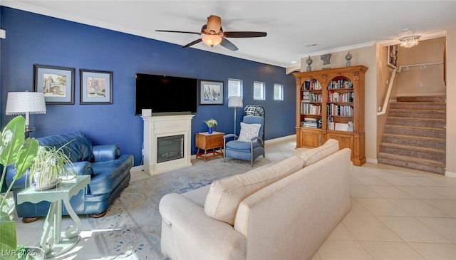 living room featuring ceiling fan, crown molding, and light tile patterned flooring