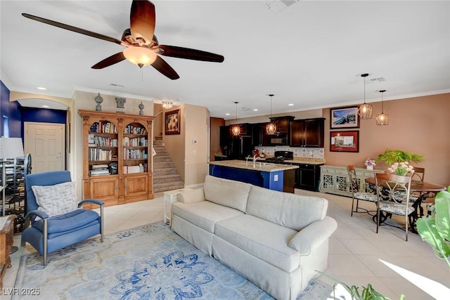 tiled living room featuring sink, ceiling fan, and ornamental molding