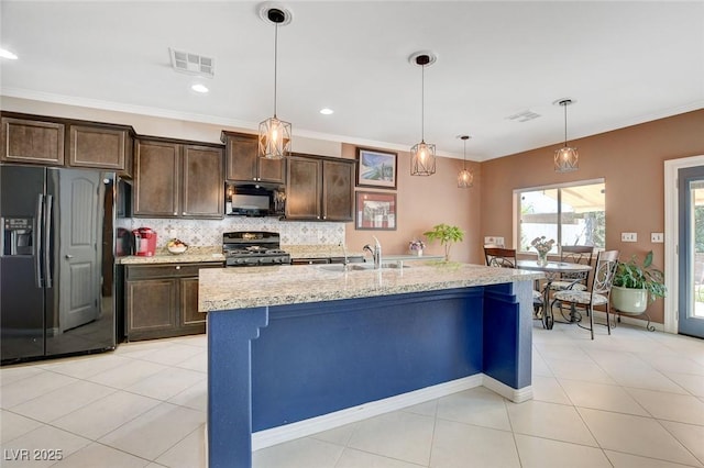 kitchen featuring dark brown cabinets, hanging light fixtures, sink, light stone countertops, and black appliances