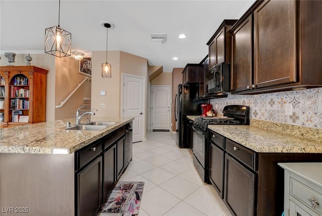 kitchen with decorative backsplash, sink, hanging light fixtures, and black appliances