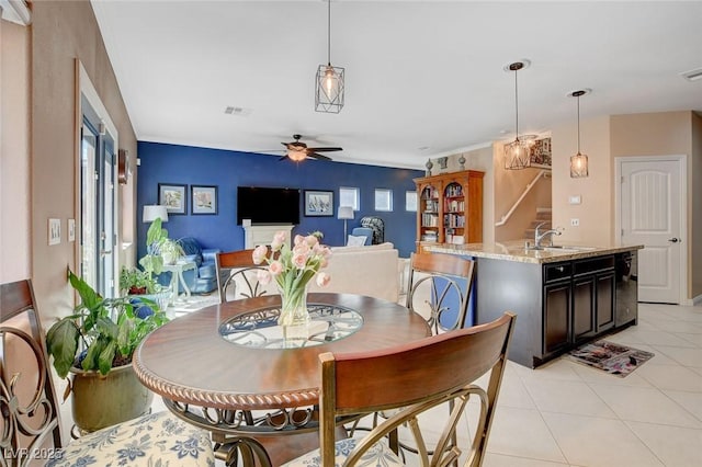 tiled dining room with sink and ceiling fan