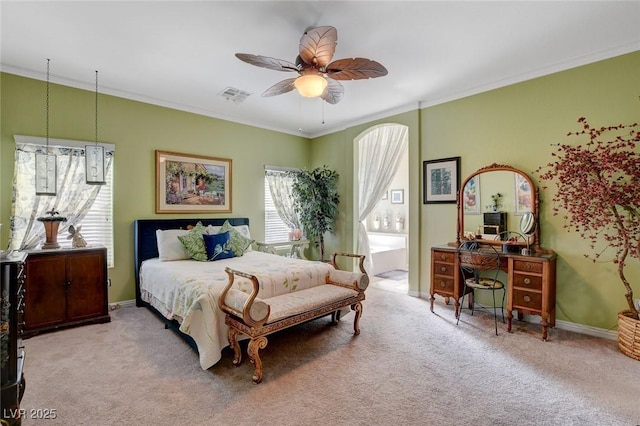 carpeted bedroom with ceiling fan and ornamental molding